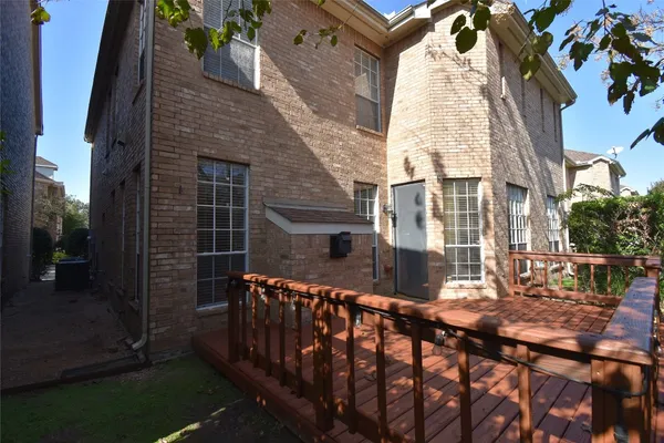 a view of a brick house with a small yard