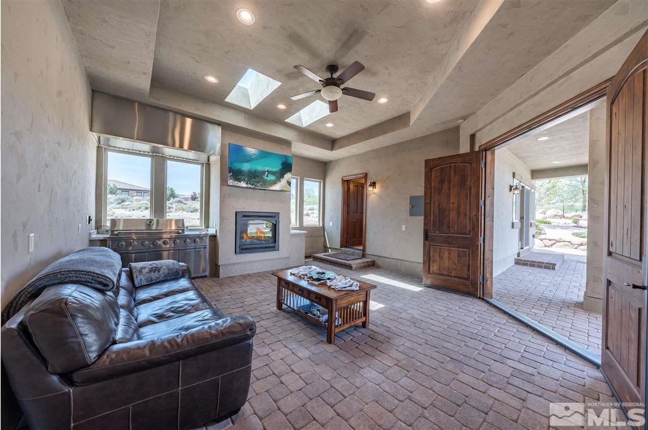 12835 Silver Wolf Road Reno, NV 89511 - Photo 12 of 31 a living room with furniture a ceiling fan and a large window