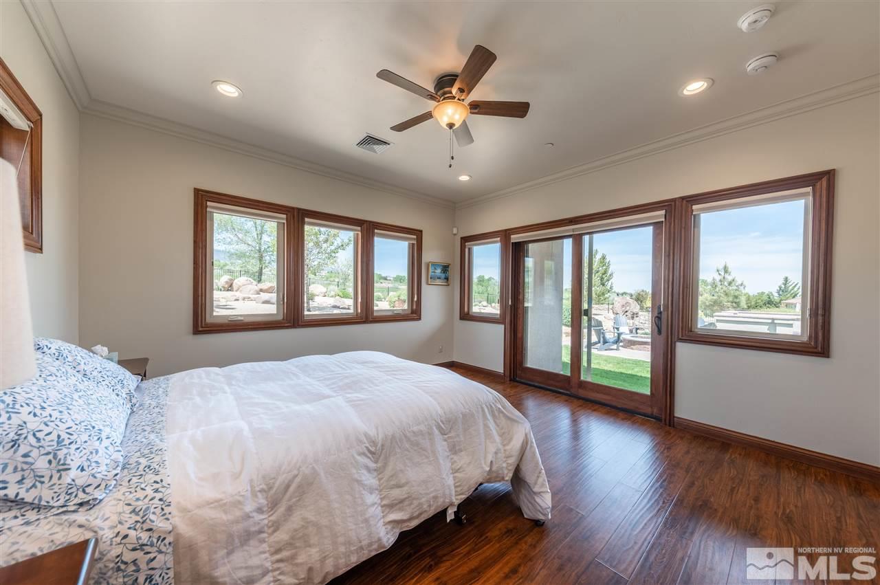 12835 Silver Wolf Road Reno, NV 89511 - Photo 15 of 31 a bedroom with a large bed and a large window