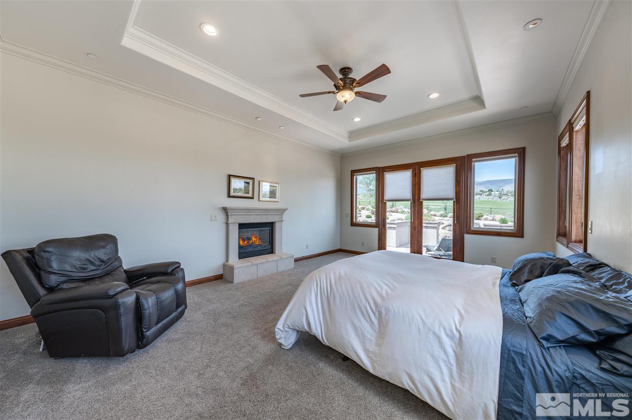 12835 Silver Wolf Road Reno, NV 89511 - Photo 18 of 31 a bedroom with a bed couch and window