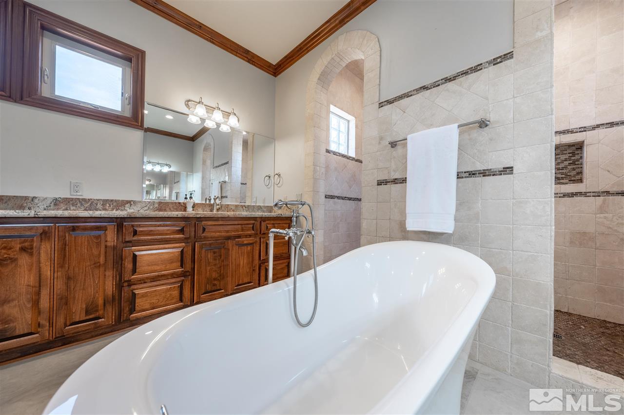 12835 Silver Wolf Road Reno, NV 89511 - Photo 22 of 31 a bathroom with a tub sink and mirror