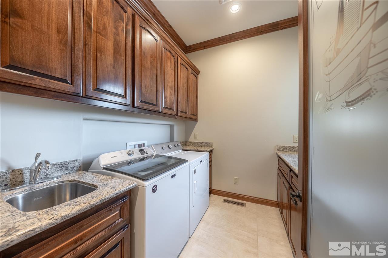 12835 Silver Wolf Road Reno, NV 89511 - Photo 23 of 31 a kitchen with stainless steel appliances granite countertop a sink and cabinets