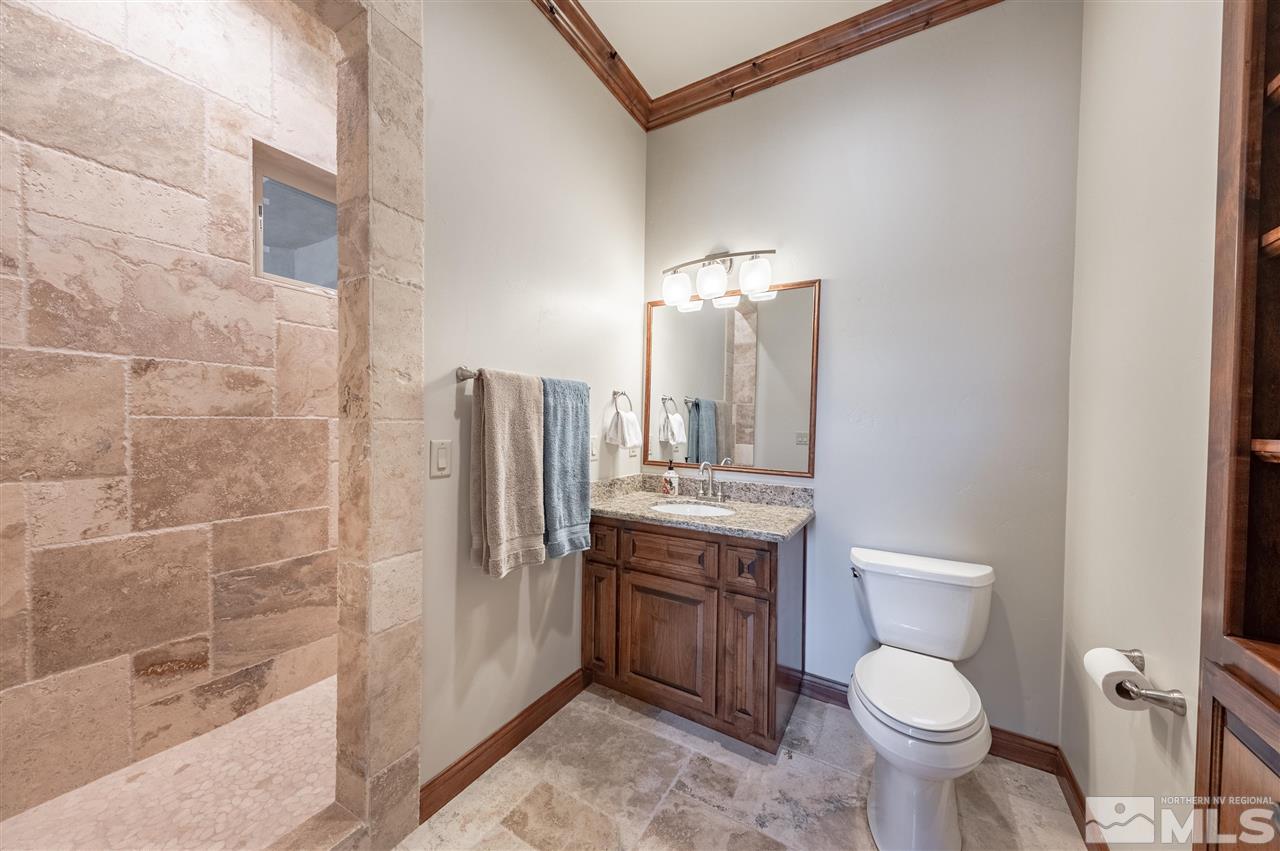 12835 Silver Wolf Road Reno, NV 89511 - Photo 24 of 31 a bathroom with a granite countertop toilet a sink and a bathtub