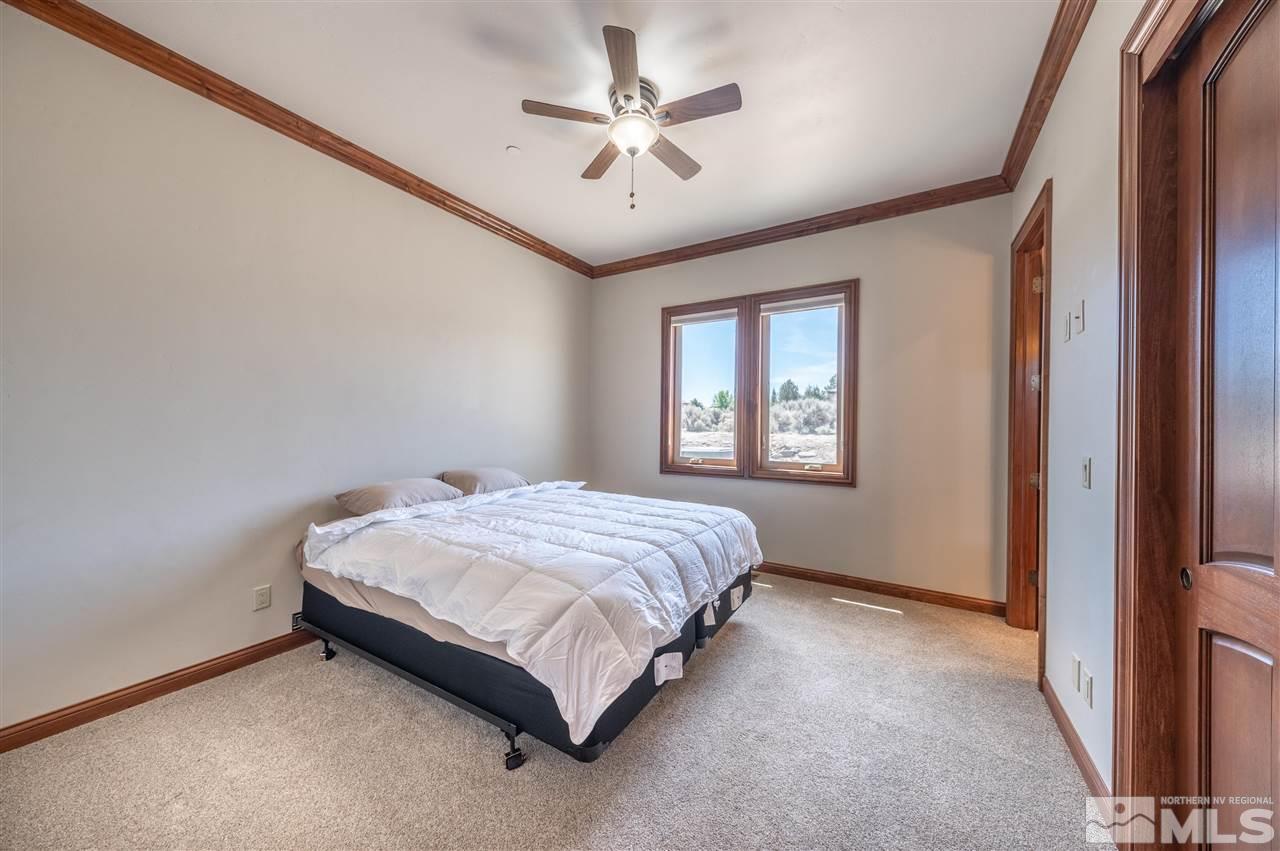 12835 Silver Wolf Road Reno, NV 89511 - Photo 26 of 31 a spacious bedroom with a bed and a window