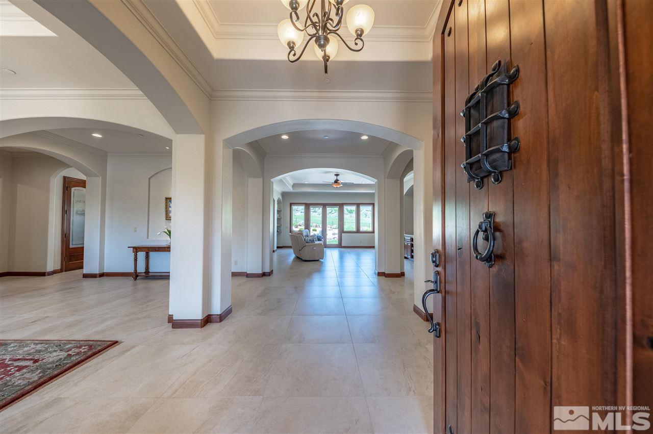 12835 Silver Wolf Road Reno, NV 89511 - Photo 3 of 31 a view of a hallway with wooden floor and stairs