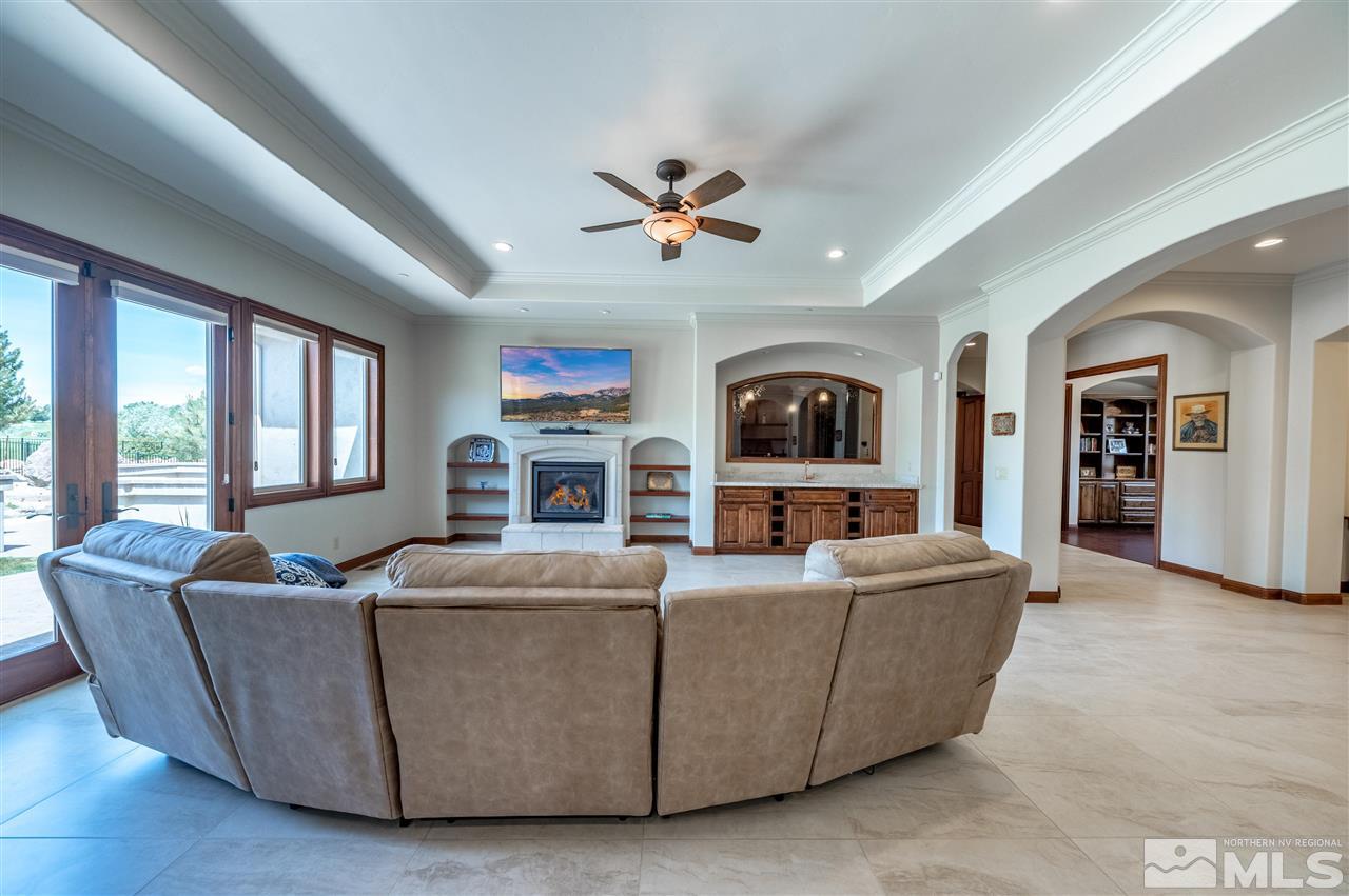 12835 Silver Wolf Road Reno, NV 89511 - Photo 6 of 31 a living room with fireplace furniture and a window