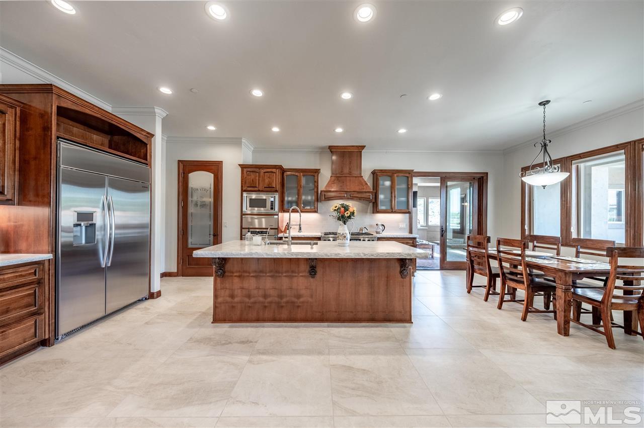 12835 Silver Wolf Road Reno, NV 89511 - Photo 8 of 31 a large kitchen with cabinets table and chairs