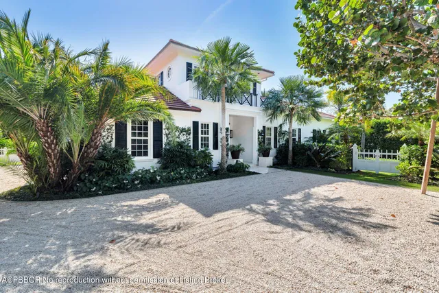 a white house with a yard and a trees
