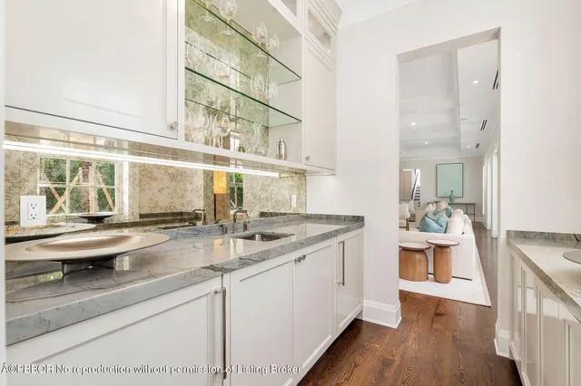a kitchen with stainless steel appliances granite countertop a sink and wooden floor
