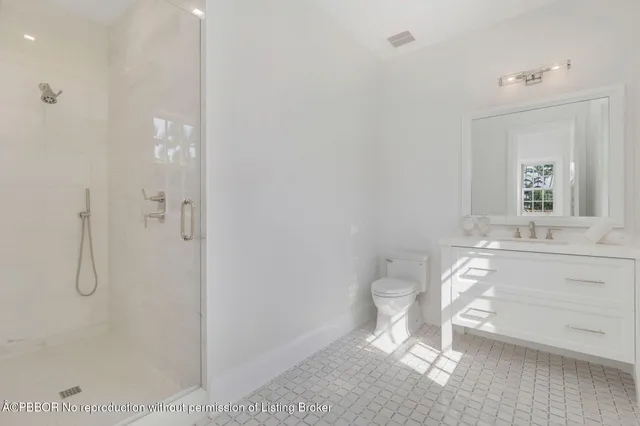 a bathroom with a granite countertop sink a toilet and a mirror