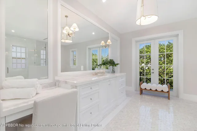 a bathroom with a granite countertop sink a large mirror and a shower