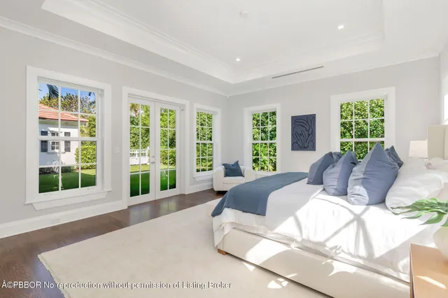 a large bedroom with a large bed and a large window