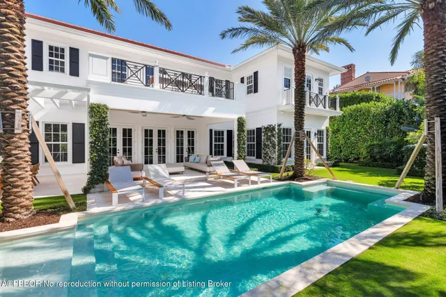 a view of a house with swimming pool and porch with furniture