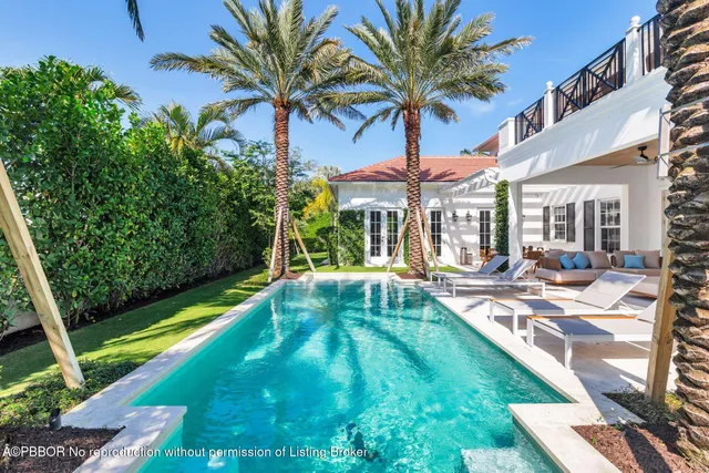 a view of a backyard with a patio and swimming pool