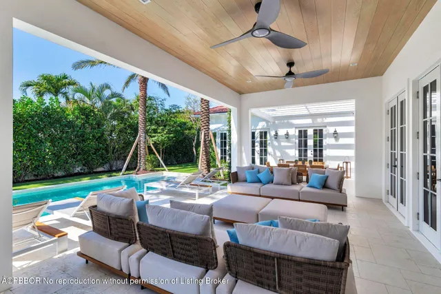 a living room with patio furniture and a yard