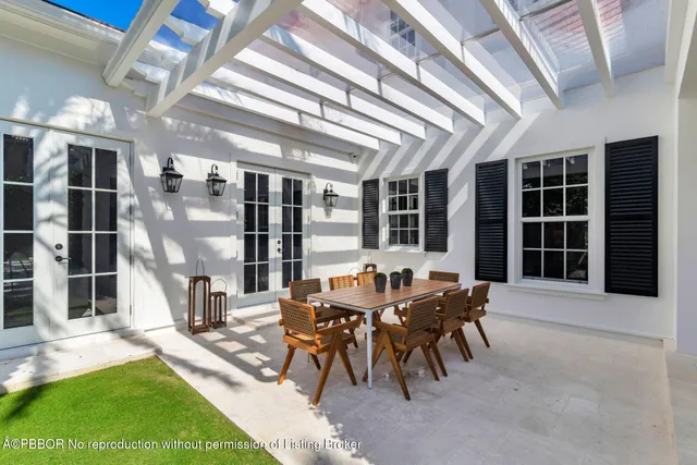 a view of a patio with table and chairs and potted plants
