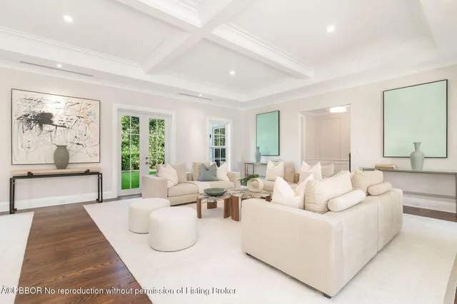 a living room with furniture potted plant and a large window
