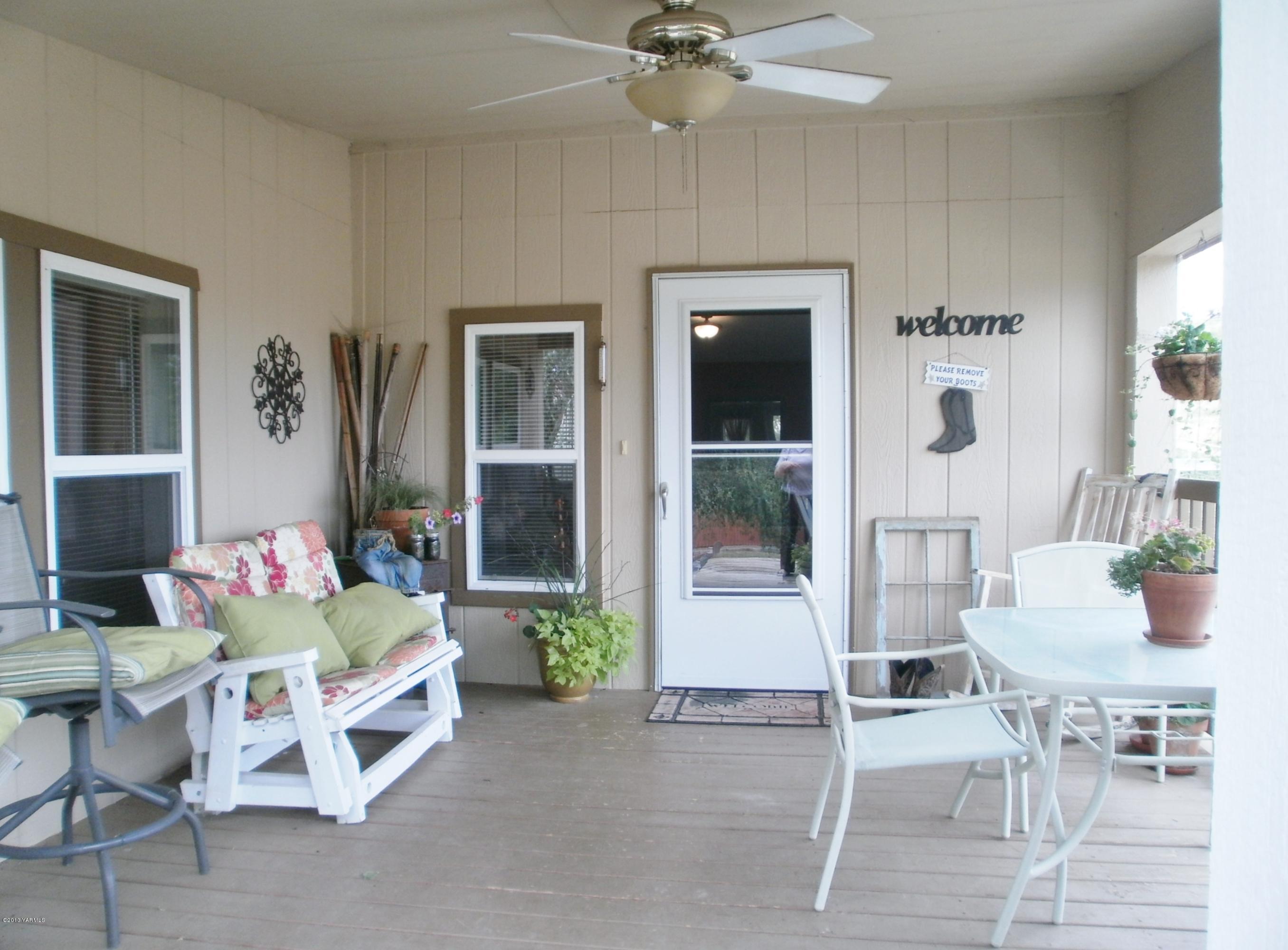1771 Stone Road Yakima, WA 98908 - Photo 4 of 45 a living room with furniture and a dining table with garden view