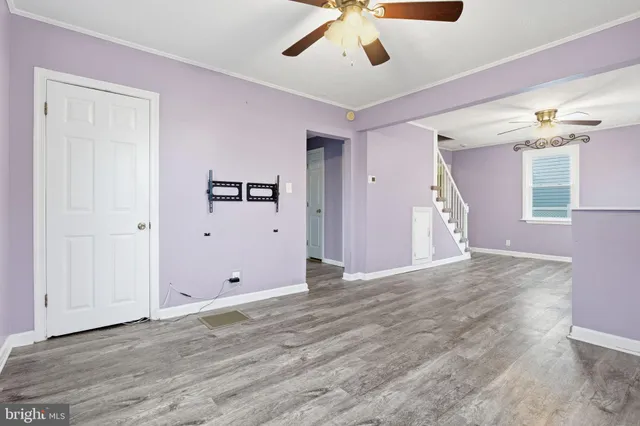 a view of empty room with wooden floor