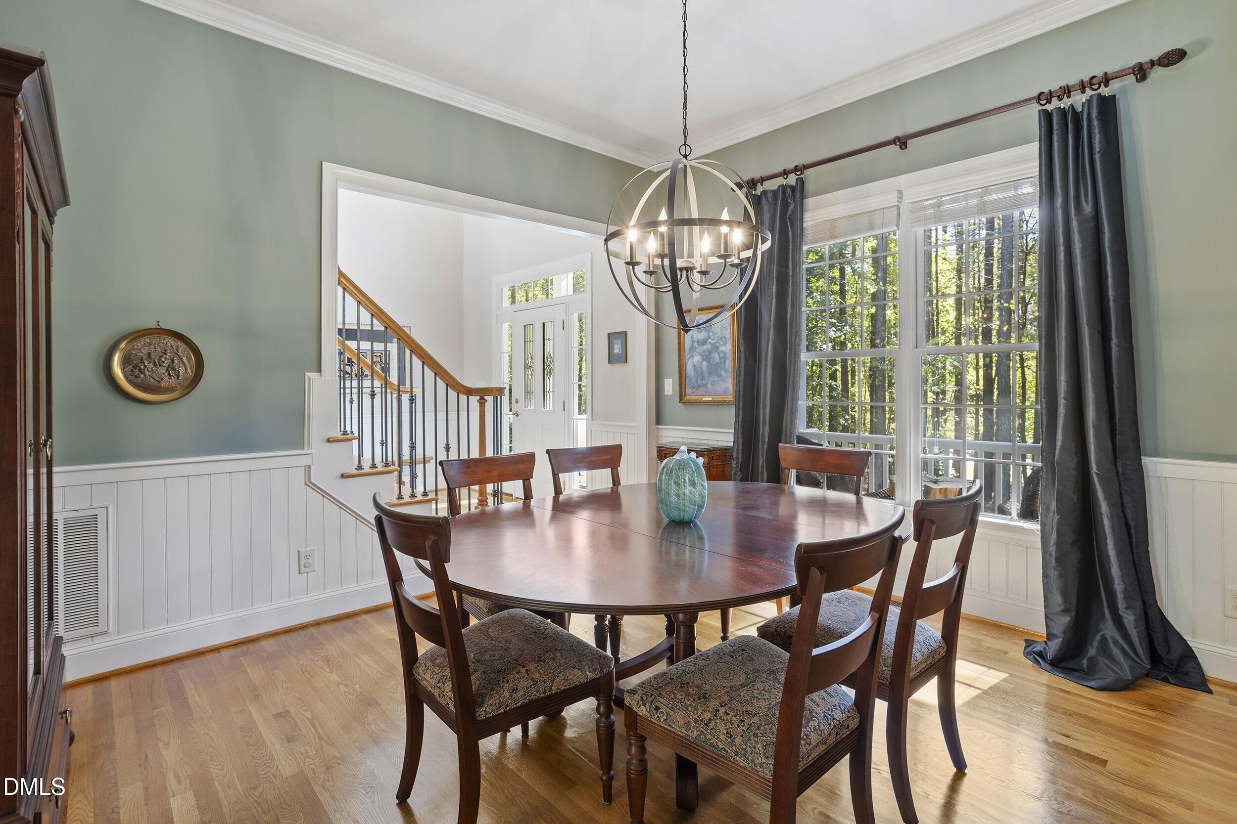 905 Olde Thompson Creek Road Apex, NC 27523 - Photo 16 of 67 a view of a dining room with furniture window and wooden floor
