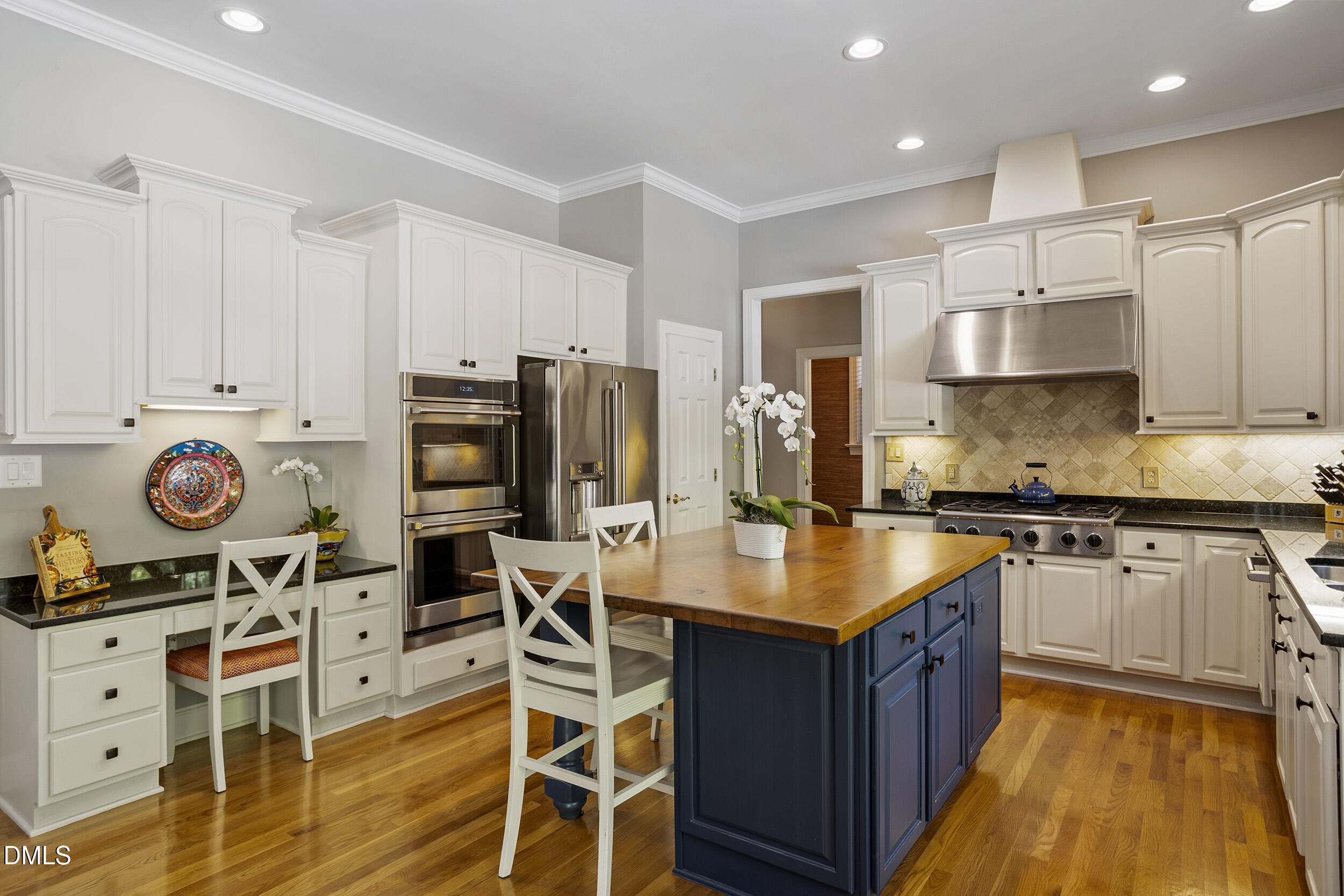 905 Olde Thompson Creek Road Apex, NC 27523 - Photo 24 of 67 a kitchen with stainless steel appliances granite countertop a stove refrigerator and cabinets
