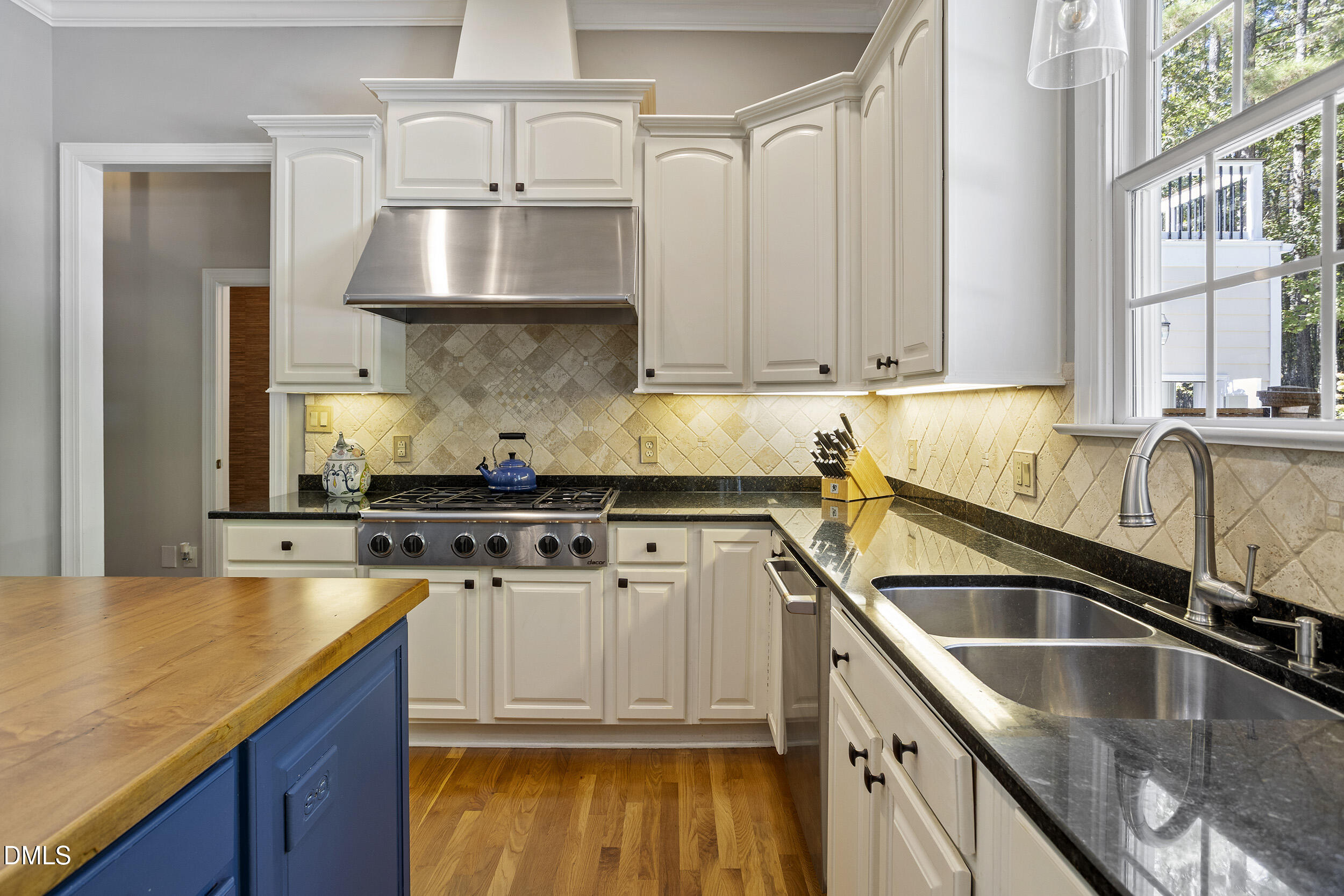 905 Olde Thompson Creek Road Apex, NC 27523 - Photo 26 of 67 a kitchen with stainless steel appliances granite countertop a sink a stove and a wooden cabinets