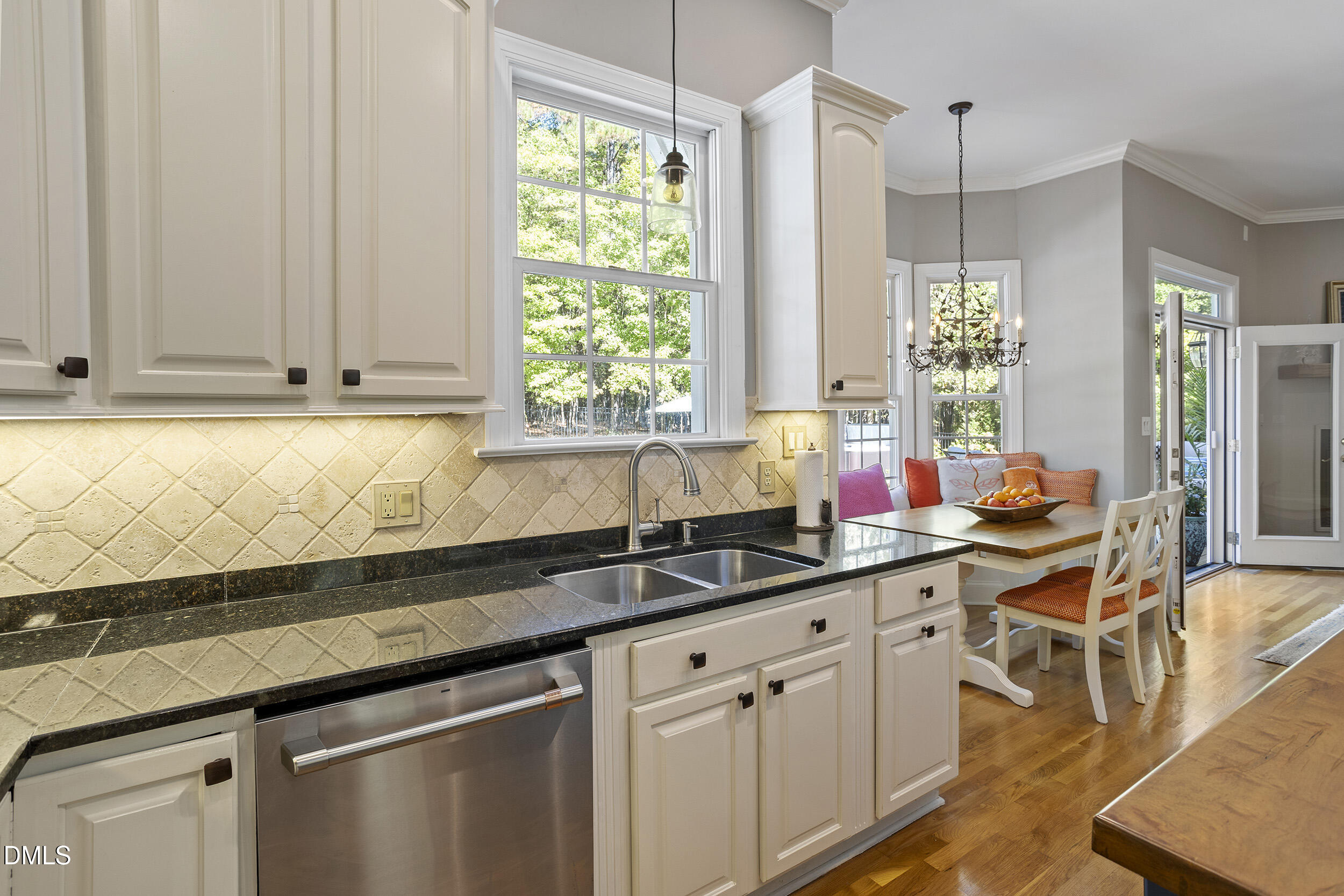 905 Olde Thompson Creek Road Apex, NC 27523 - Photo 27 of 67 a kitchen with stainless steel appliances white cabinets and a granite counter tops