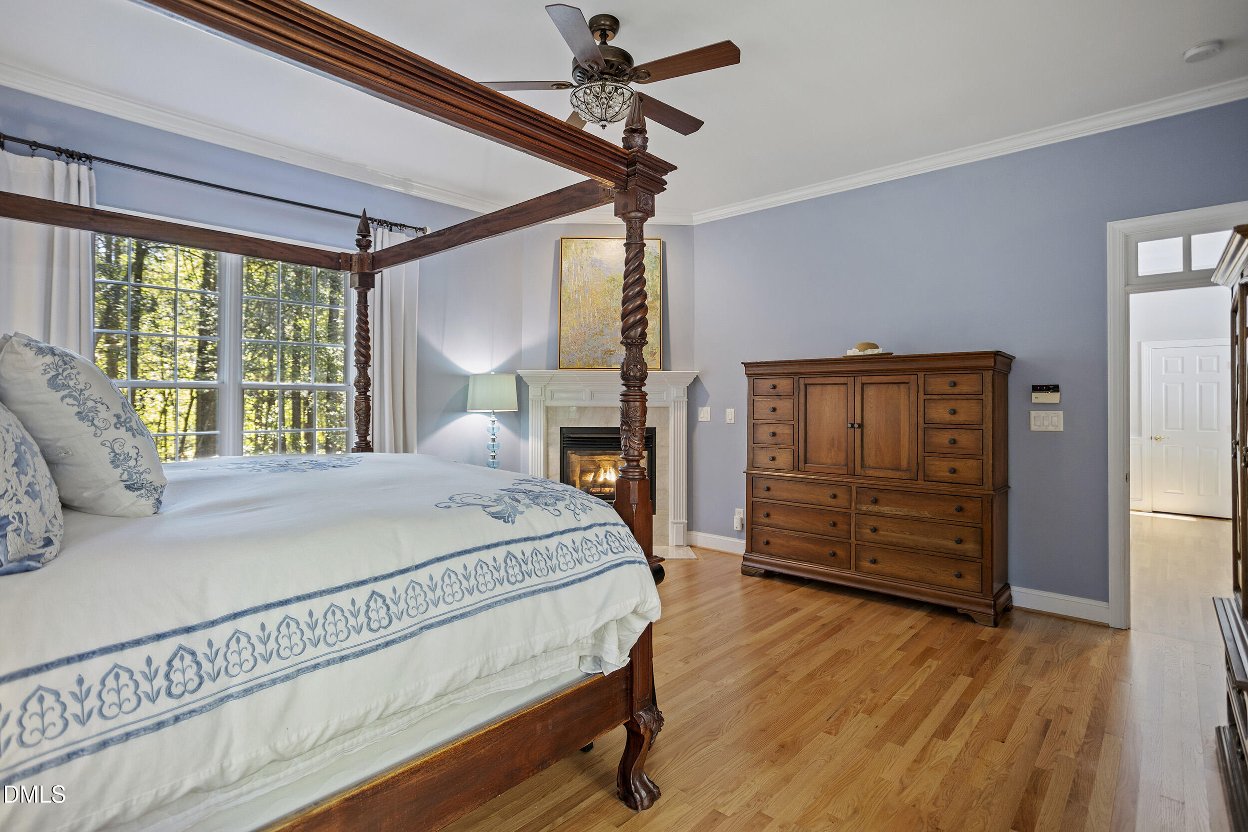 905 Olde Thompson Creek Road Apex, NC 27523 - Photo 35 of 67 a bedroom with a bed a dresser and wooden floor