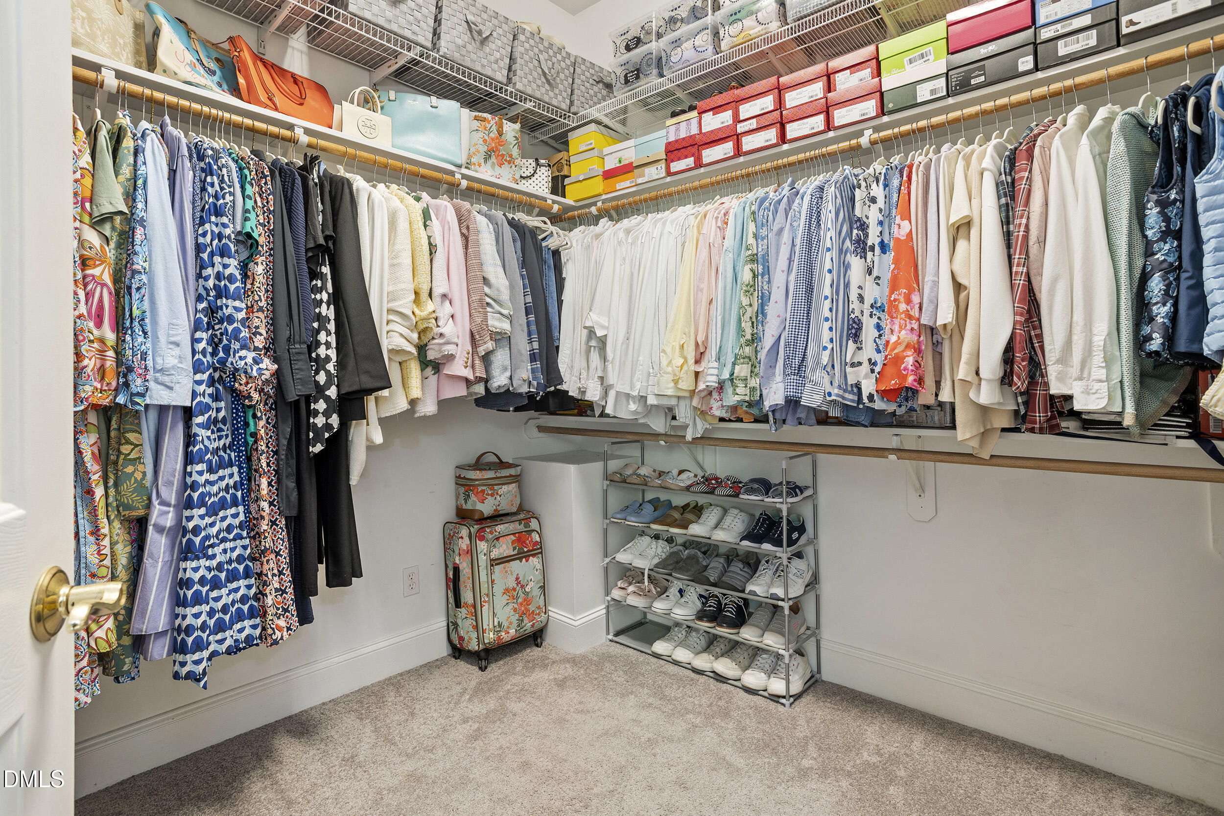 905 Olde Thompson Creek Road Apex, NC 27523 - Photo 37 of 67 a view of walk in closet with clothes and shoes