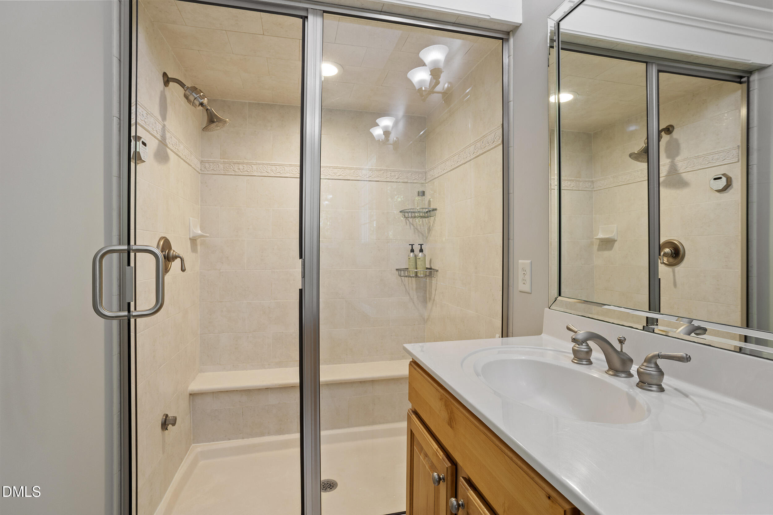 905 Olde Thompson Creek Road Apex, NC 27523 - Photo 39 of 67 a bathroom with a granite countertop sink a shower and a mirror