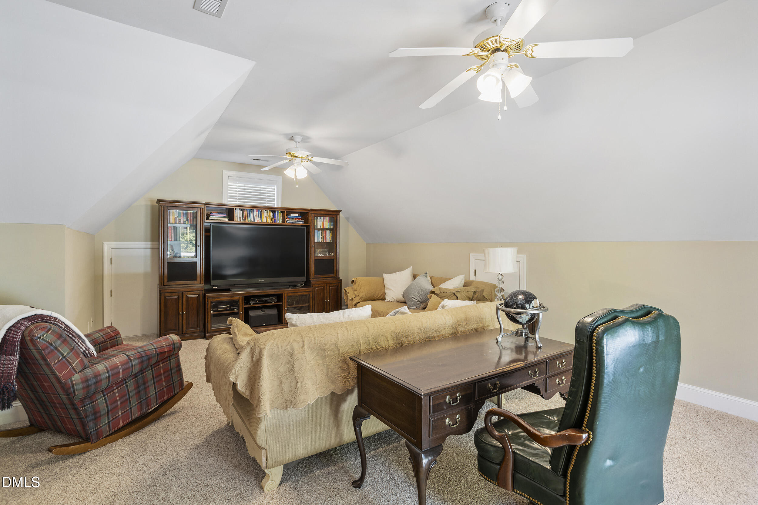 905 Olde Thompson Creek Road Apex, NC 27523 - Photo 44 of 67 a living room with furniture and a flat screen tv