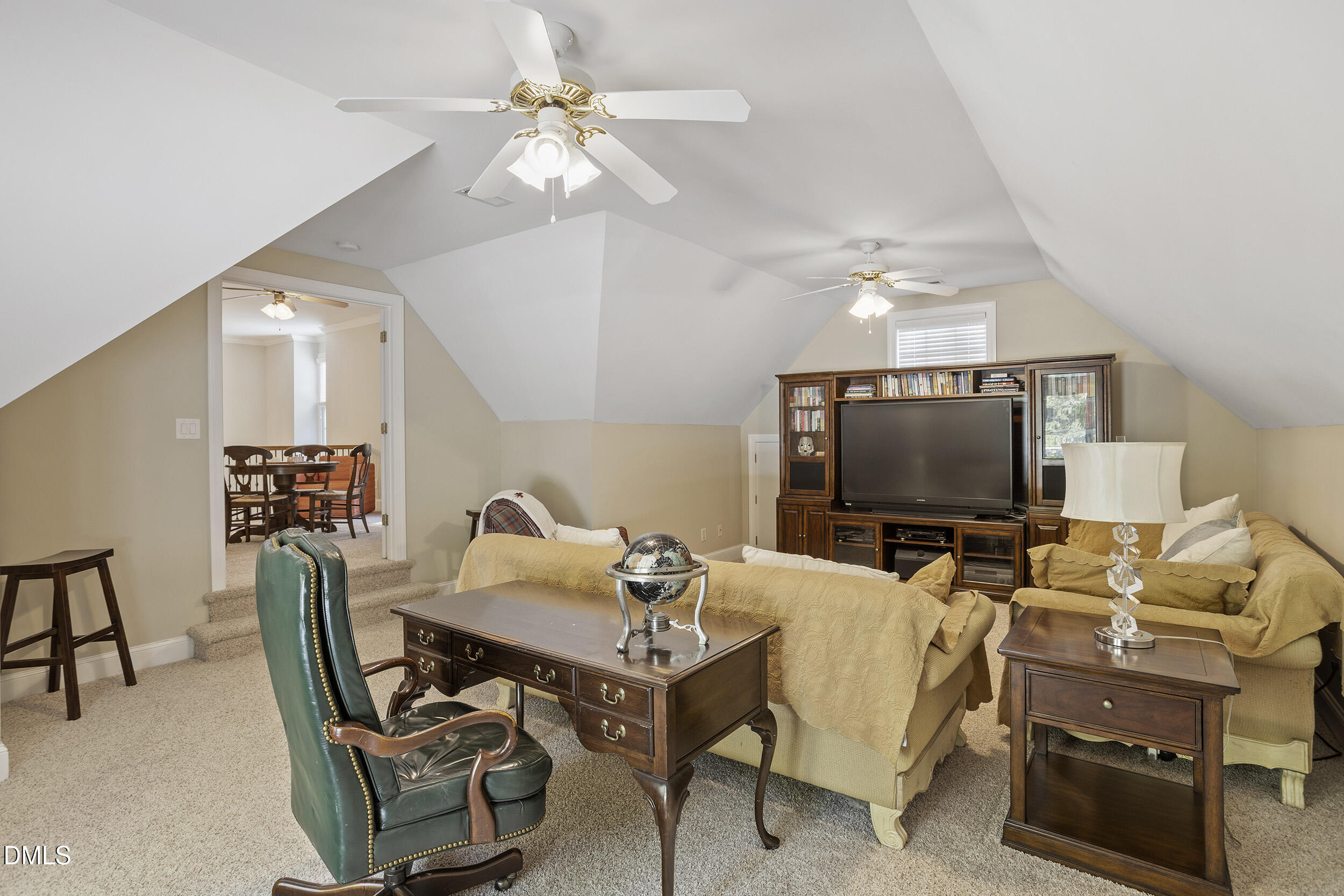 905 Olde Thompson Creek Road Apex, NC 27523 - Photo 45 of 67 a living room with furniture and a flat screen tv