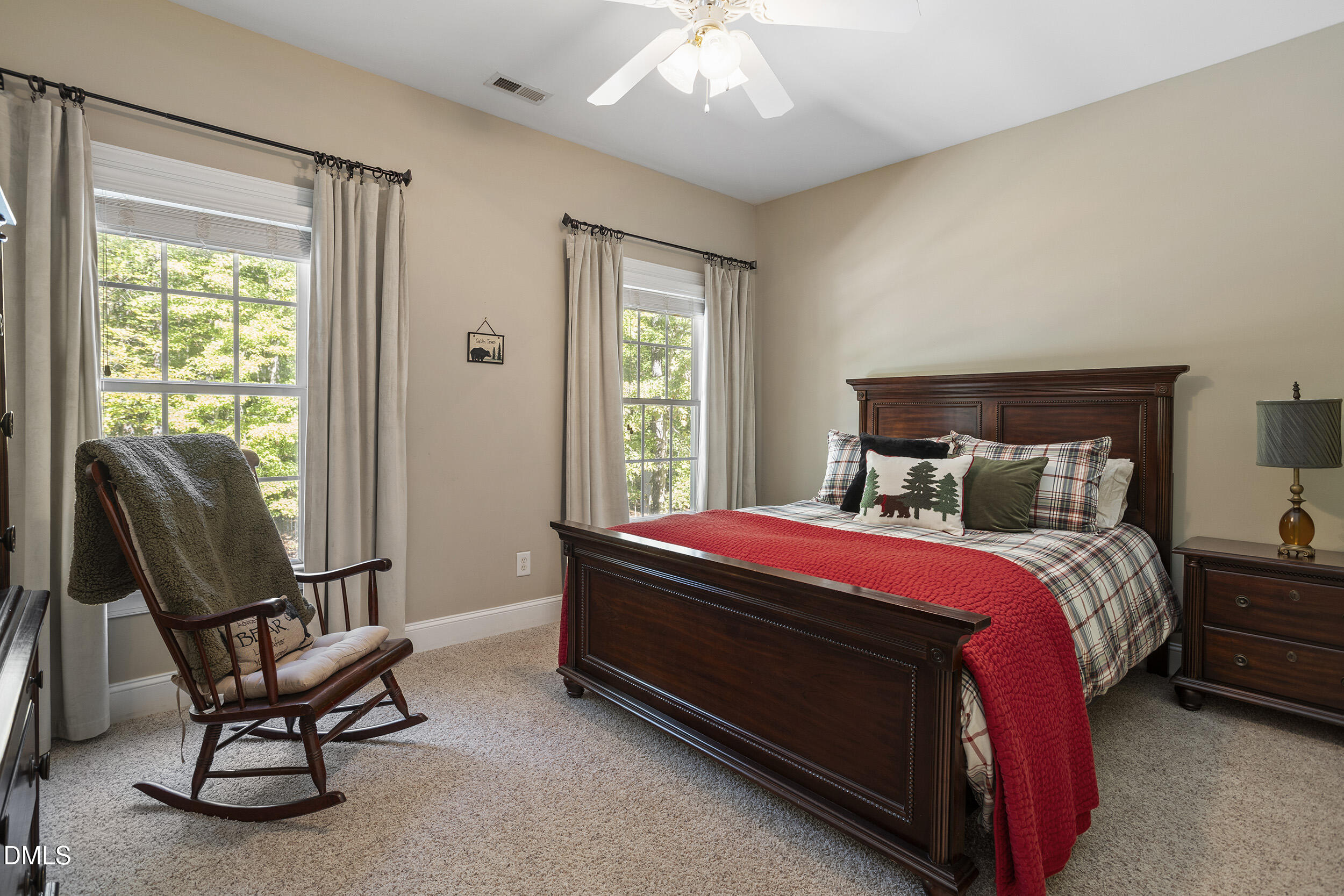 905 Olde Thompson Creek Road Apex, NC 27523 - Photo 48 of 67 a bed sitting in a bedroom next to a window