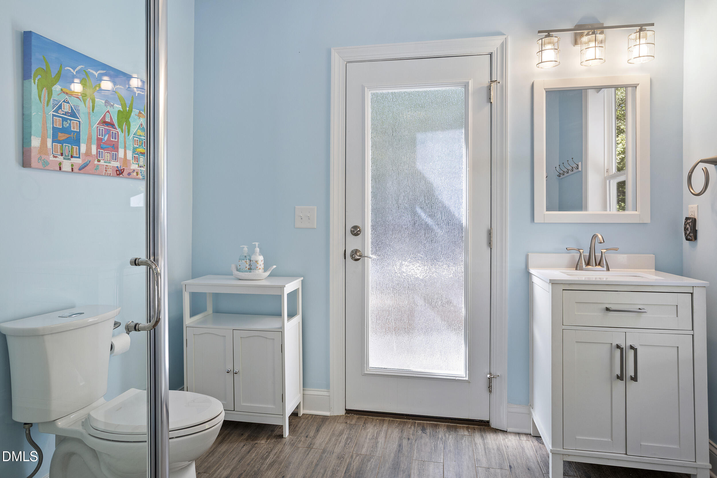 905 Olde Thompson Creek Road Apex, NC 27523 - Photo 53 of 67 a bathroom with a sink a toilet and shower
