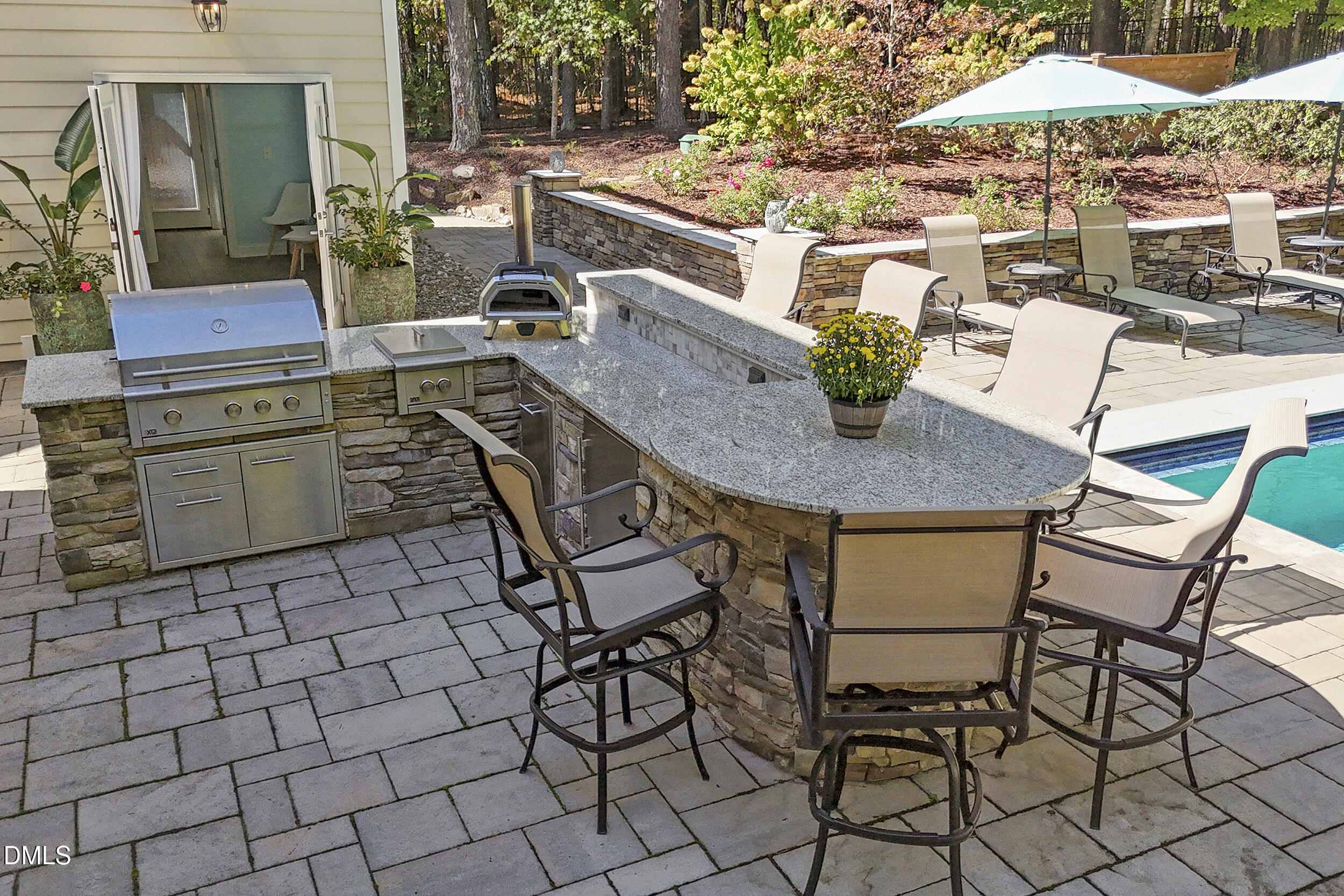 905 Olde Thompson Creek Road Apex, NC 27523 - Photo 64 of 67 a dinning table and chairs in a patio