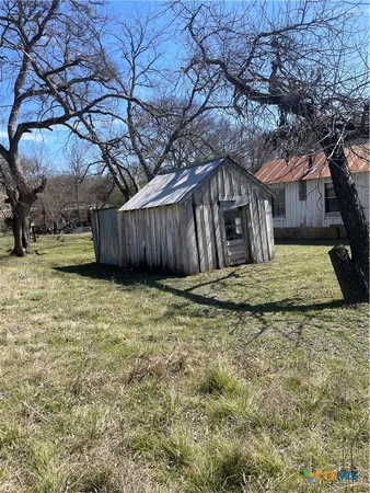 a view of a backyard of the house
