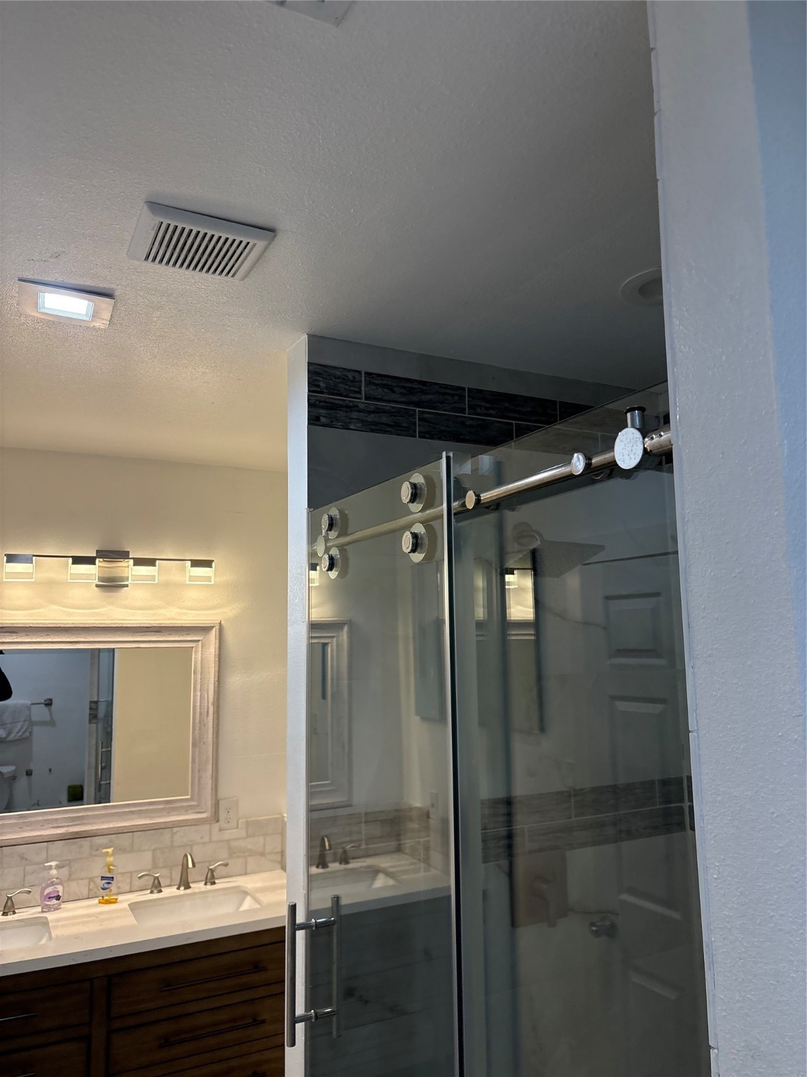 3021 Gray Street Houston, TX 77004 - Photo 13 of 37 a bathroom with a shower sink and mirror