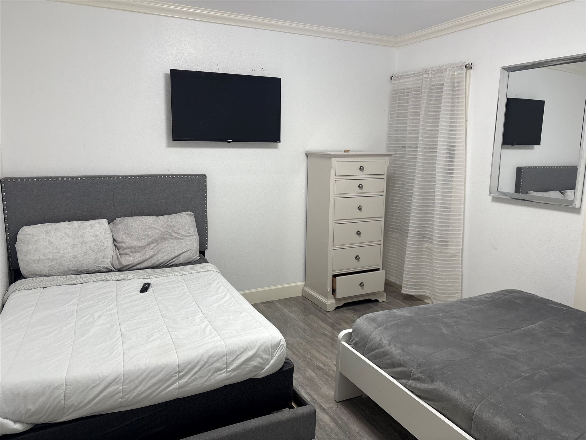 3021 Gray Street Houston, TX 77004 - Photo 15 of 37 a bedroom with a bed and a flat screen tv