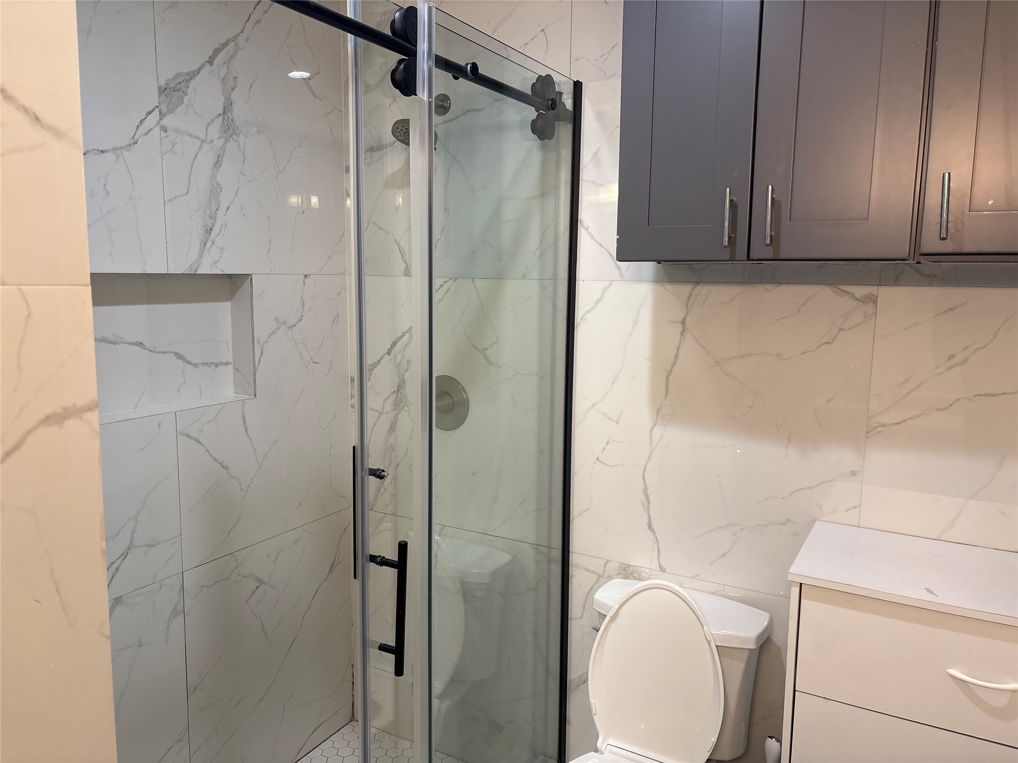 3021 Gray Street Houston, TX 77004 - Photo 18 of 37 a bathroom with a shower a toilet and sink