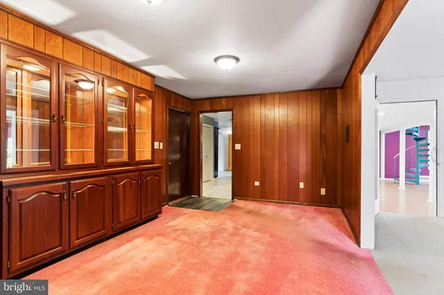 a view of an empty room with window and stairs