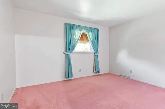 a view of a room with a small yard and a window