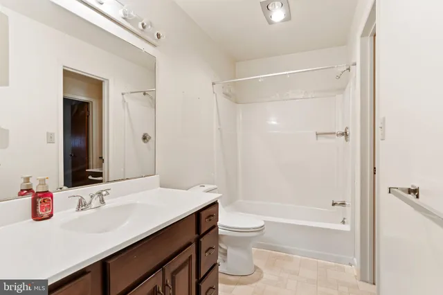 a bathroom with a sink toilet vanity and shower