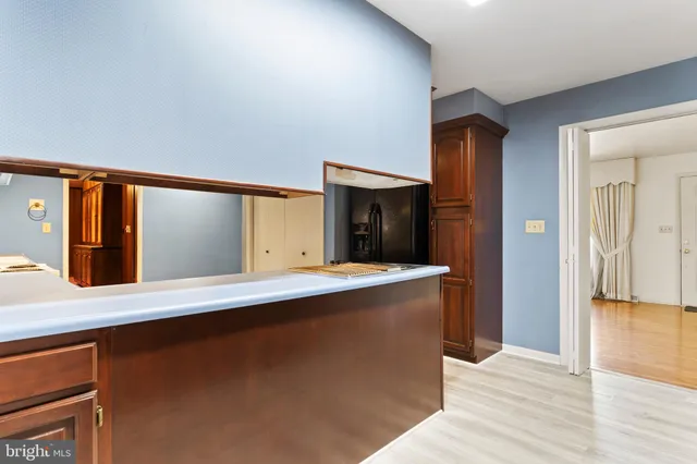 a view of a living room with a sink and wooden floor