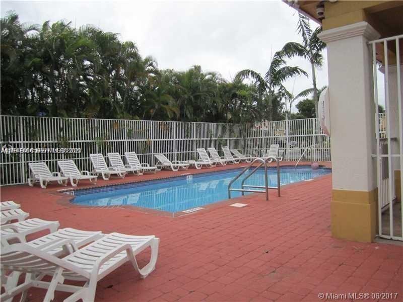 60 Southeast 6th Road, Unit 60 Homestead, FL 33030 - Photo 13 of 15 a view of a swimming pool with a lounge chair