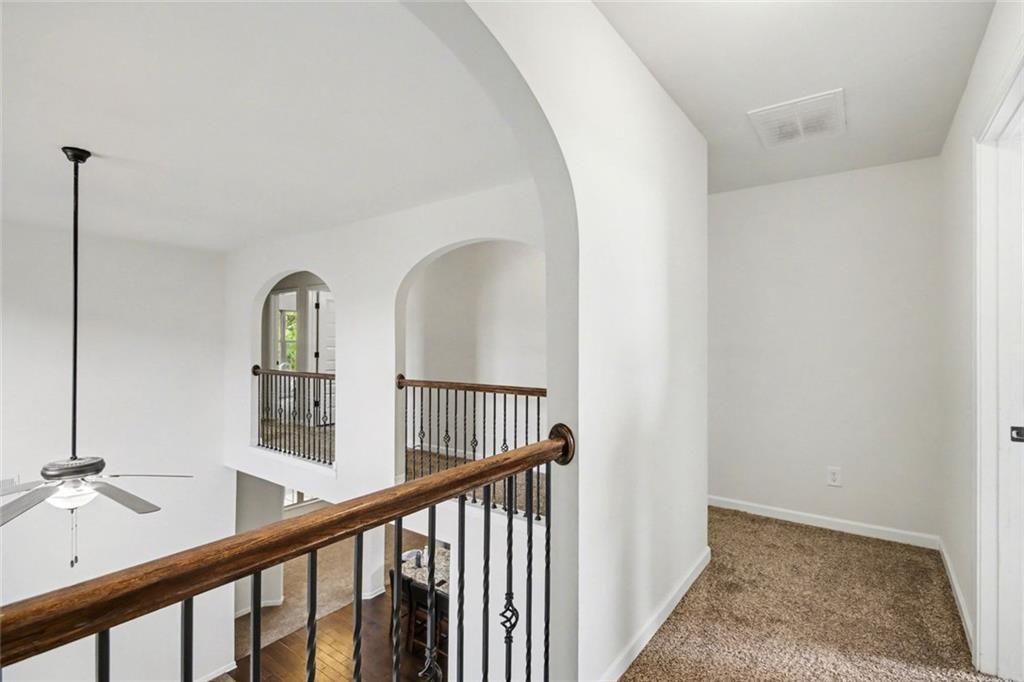 767 Effendi Place Fairburn, GA 30213 - Photo 17 of 35 a view of staircase with railing and white walls