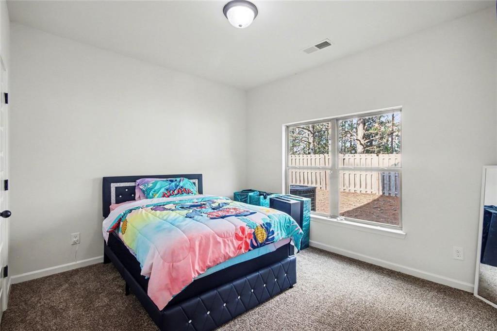 767 Effendi Place Fairburn, GA 30213 - Photo 19 of 35 a bedroom with a bed and a window