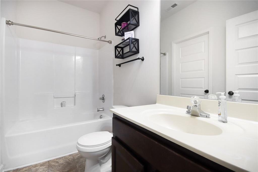 767 Effendi Place Fairburn, GA 30213 - Photo 21 of 35 a bathroom with a sink a toilet and shower