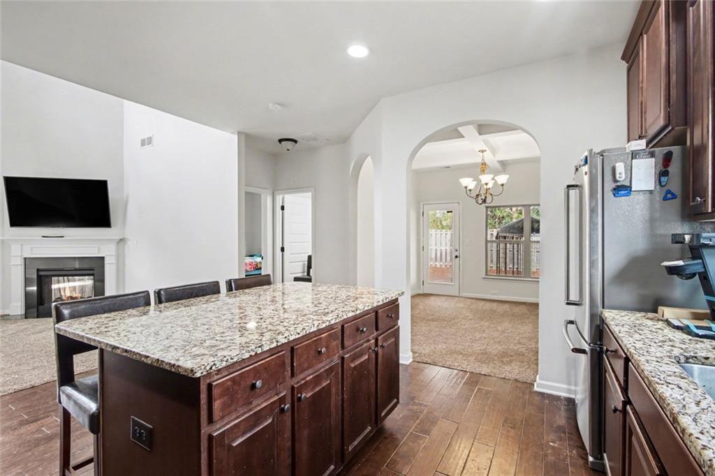 767 Effendi Place Fairburn, GA 30213 - Photo 22 of 35 a kitchen with a stove and a view living room