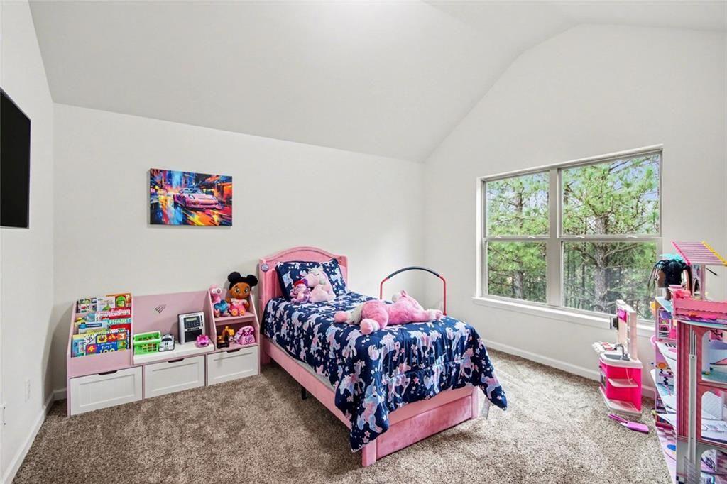 767 Effendi Place Fairburn, GA 30213 - Photo 23 of 35 a bedroom with bed and a large window