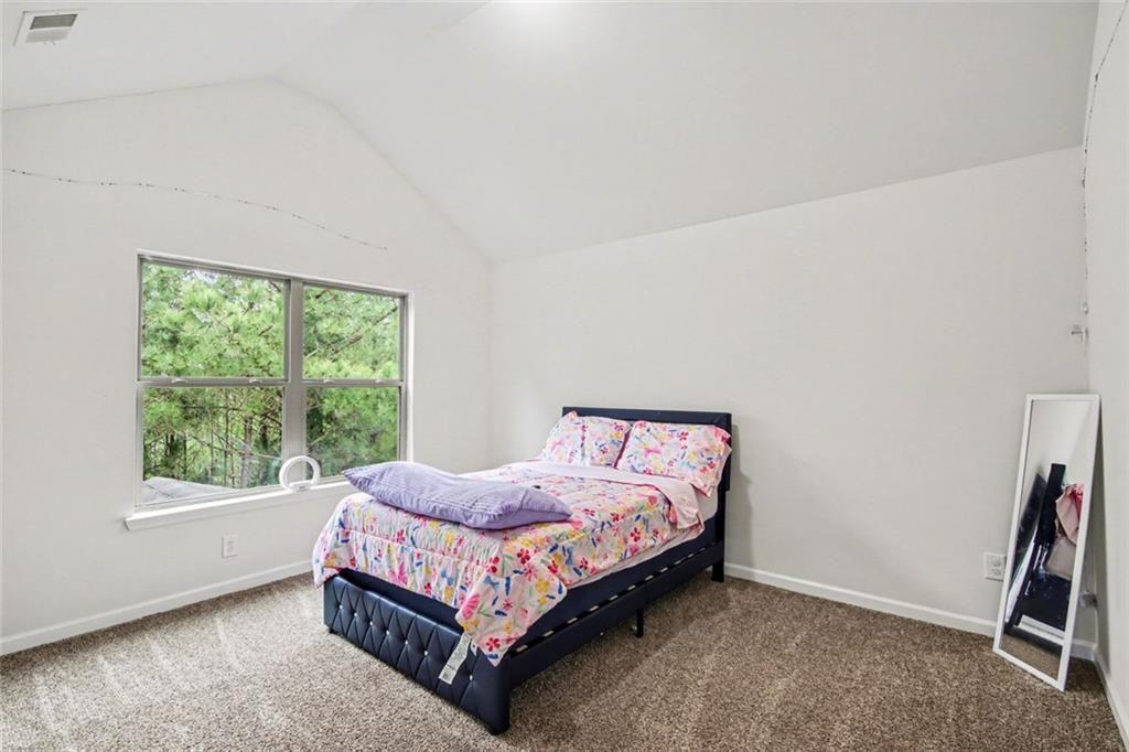 767 Effendi Place Fairburn, GA 30213 - Photo 24 of 35 a bedroom with a bed and a window
